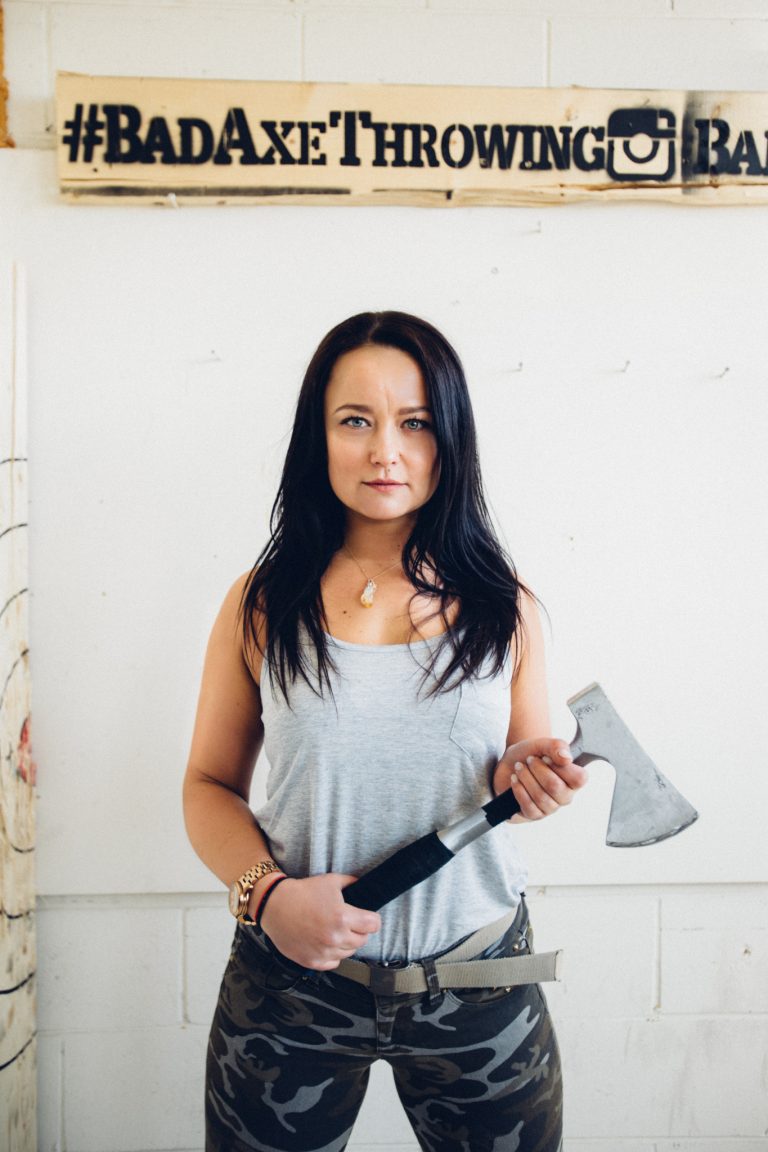 Coach Edyta standing with axe at Bad Axe Throwing