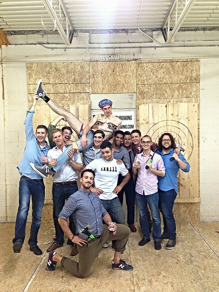 Group shot of bachelor party holding up the groom at Bad Axe Throwing Toronto